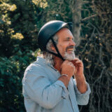 Man fastening bike helmet